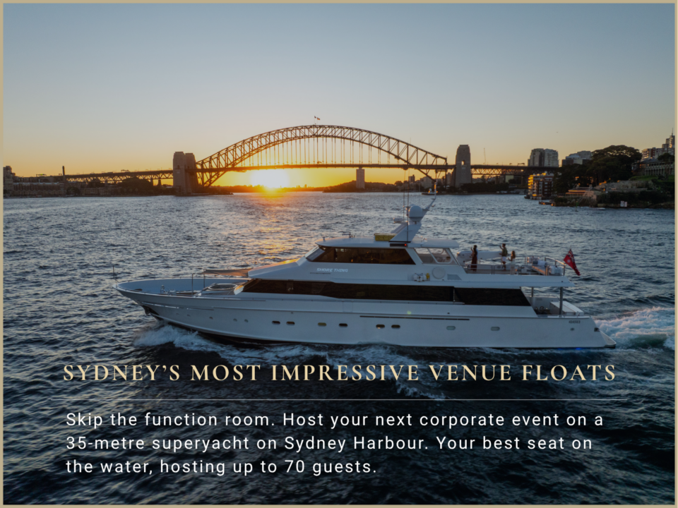 A white superyacht cruises on Sydney Harbour with the Sydney Harbour Bridge in the background at sunset, accompanied by the text “Sydney’s most impressive venue floats.”.